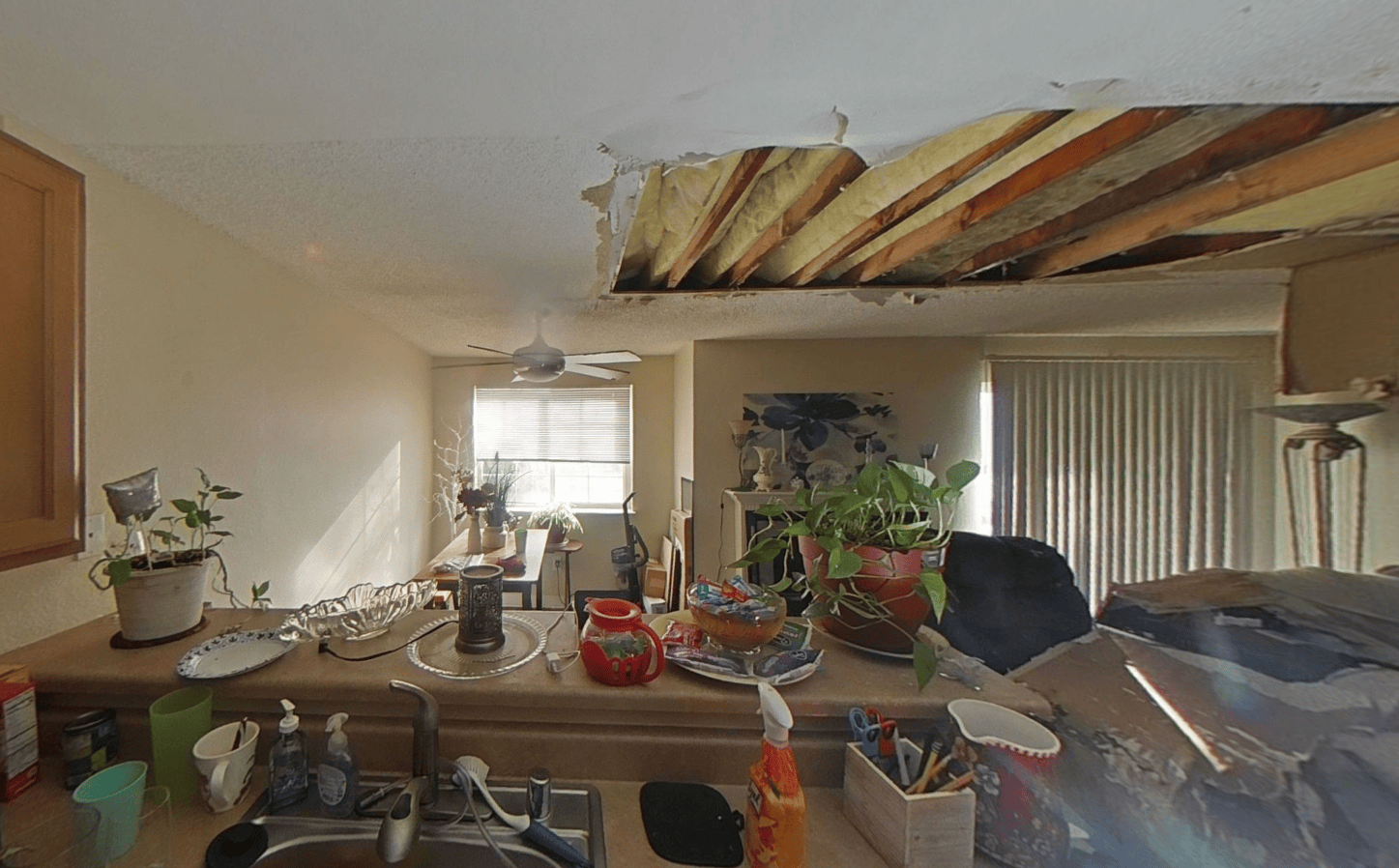 Kitchen view showing exposed ceiling structure and damage after the explosion loss