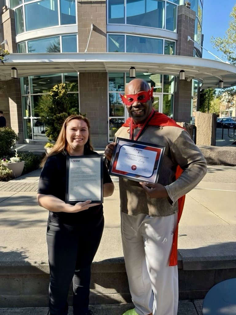 Paiton awarding Maurice with PuroClean Cares Superhero Award