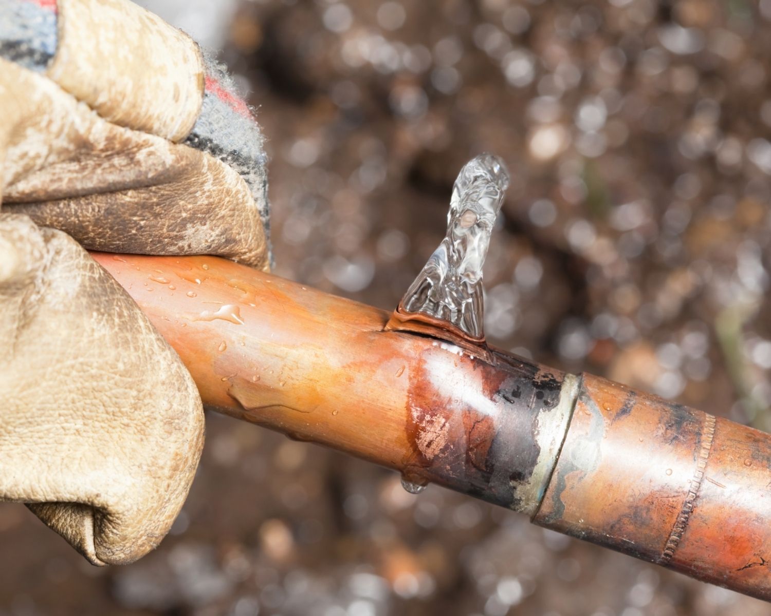 Frozen copper pipe with visible burst damage