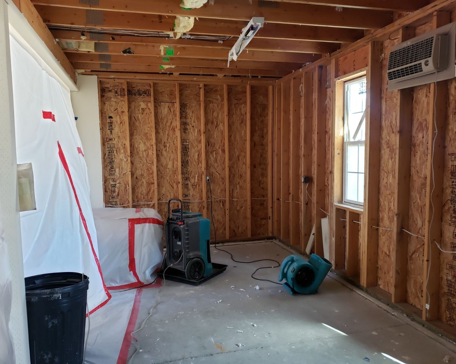 Interior wall stripped to studs during water damage mitigation