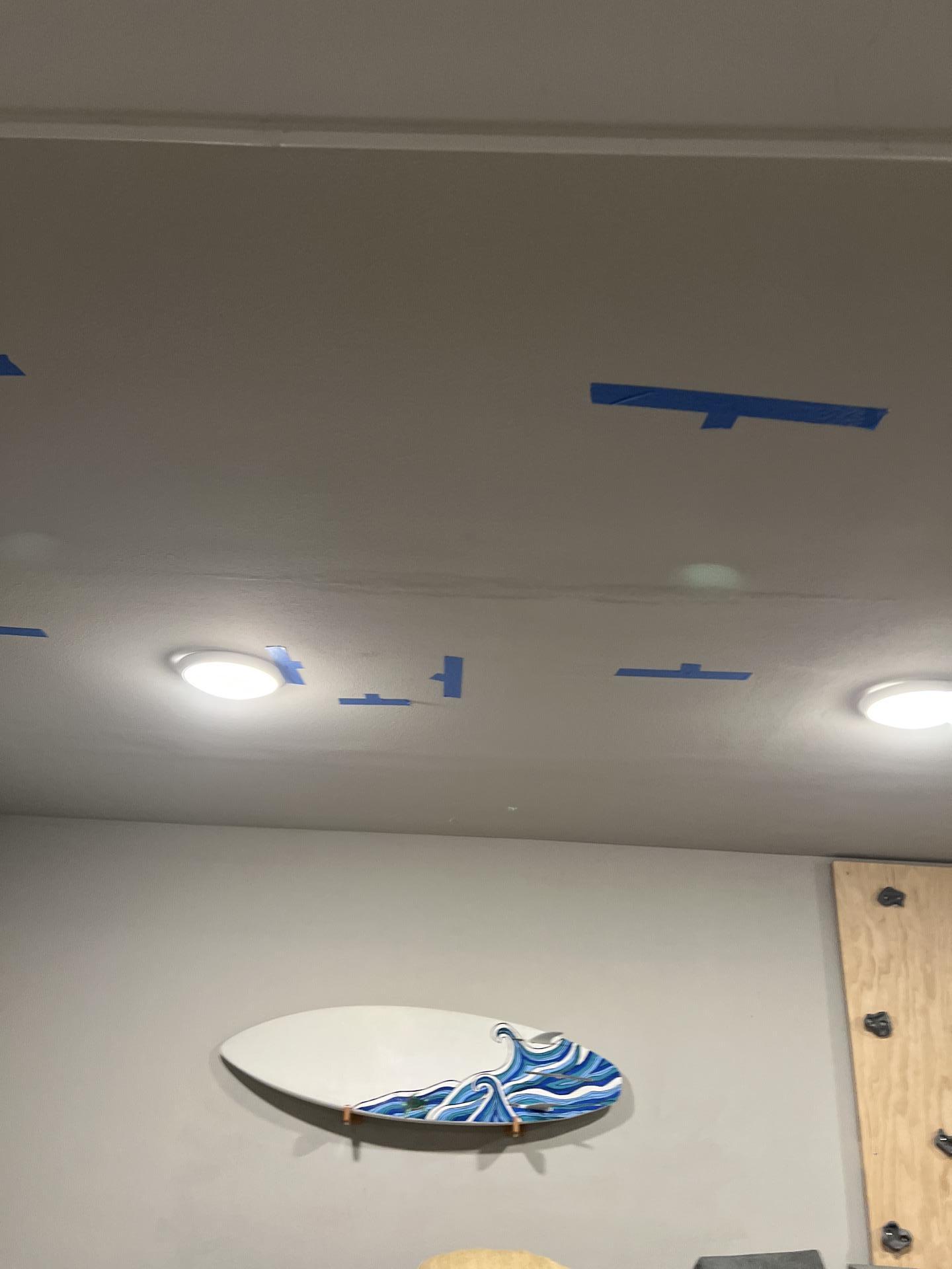 Ceiling water damage with marked leak areas