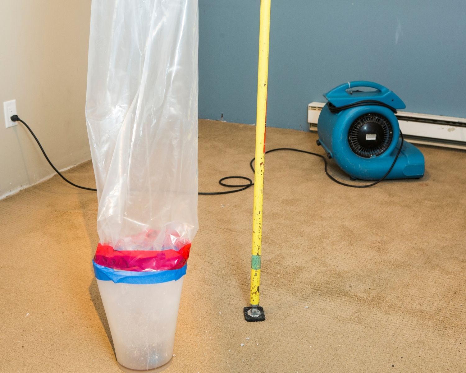 Professional air movers positioned on carpet during water damage restoration