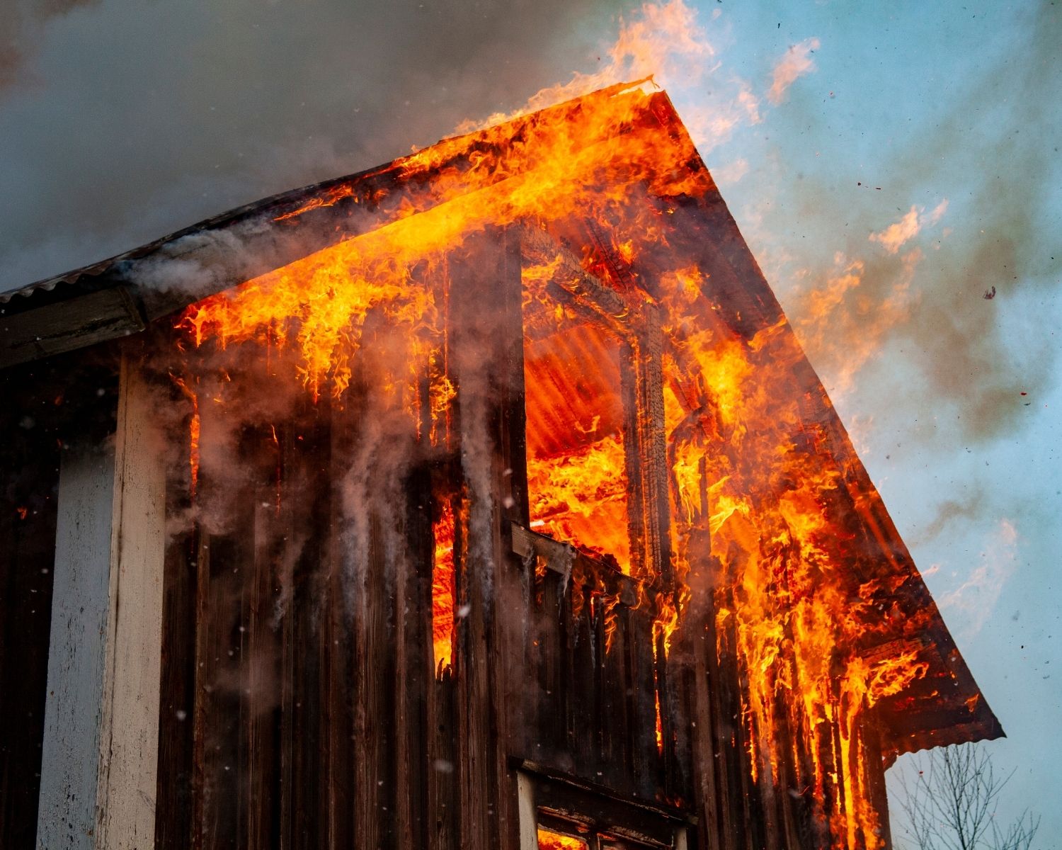 Active house fire causing severe structural damage to a residential home