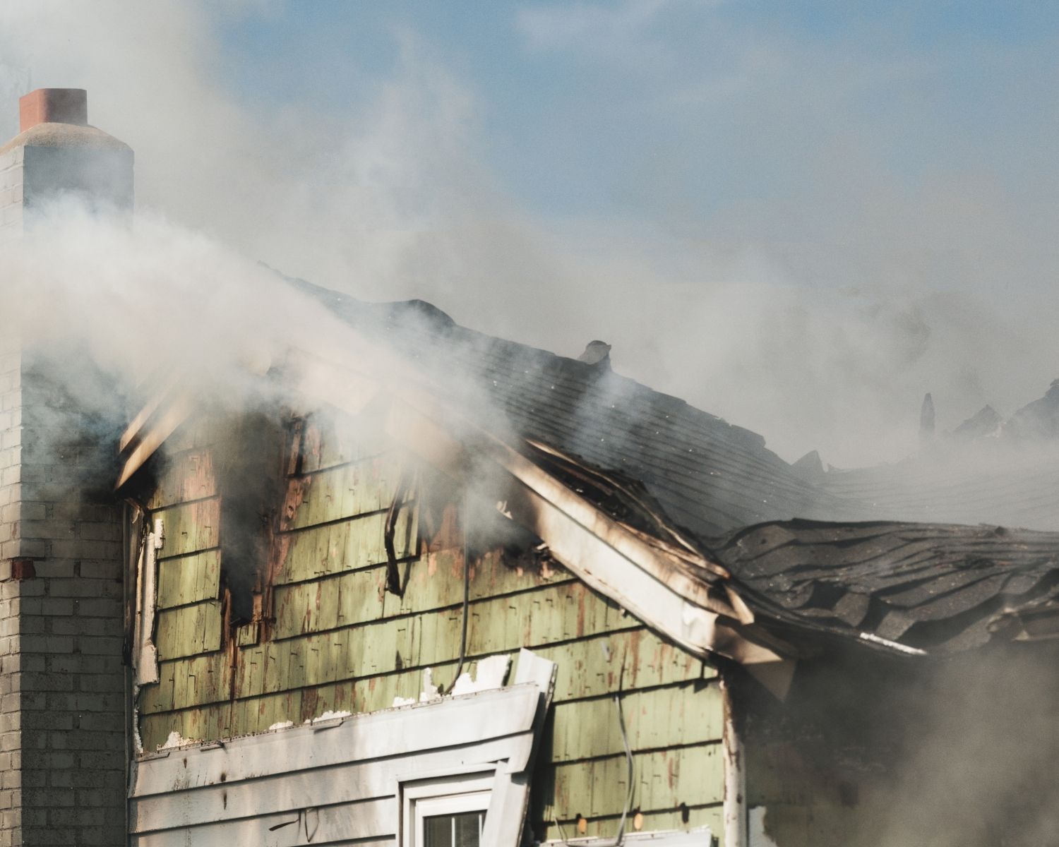 Smoke damage visible on house exterior requiring professional restoration assessment