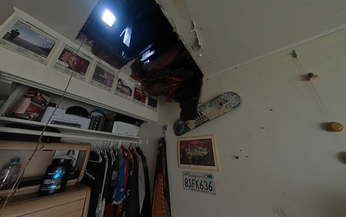 Closet with burned ceiling and smoke-stained walls after fire