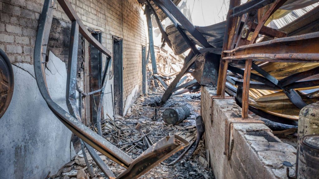 crew performing room-by-room smoke damage inspection with moisture meter and cleaning tools