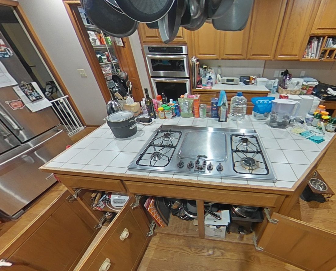 Close-up of kitchen island gas cooktop and open cabinets below showing ABC powder contamination