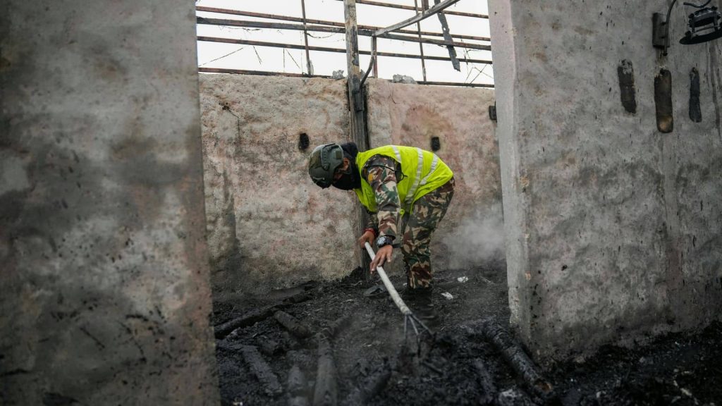 technician cleaning soot from structural surfaces while another sets drying equipment