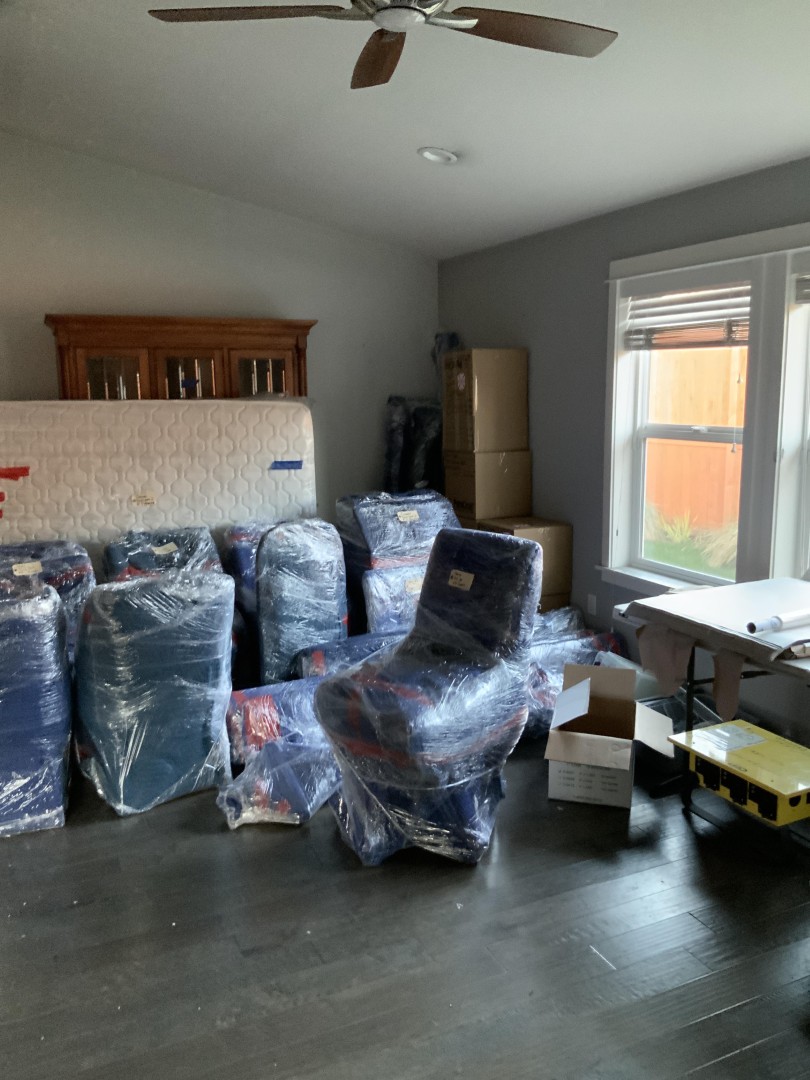Furniture wrapped and staged for pack-out and off-site contents cleaning