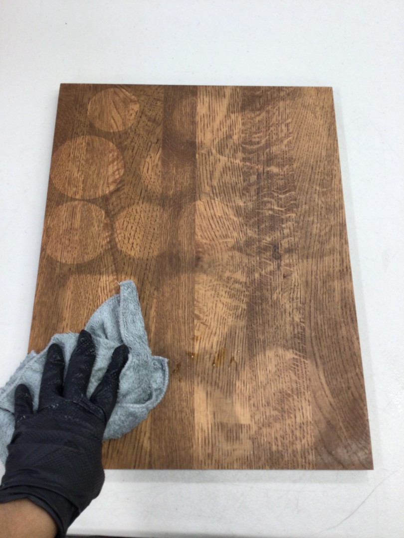 Technician performing detailed soot removal from wood furniture by hand