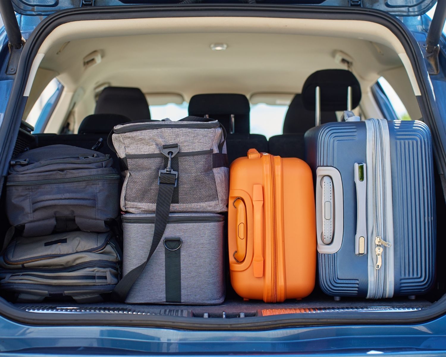 Family packing a suitcase with clothing and essentials for a temporary stay away from home
