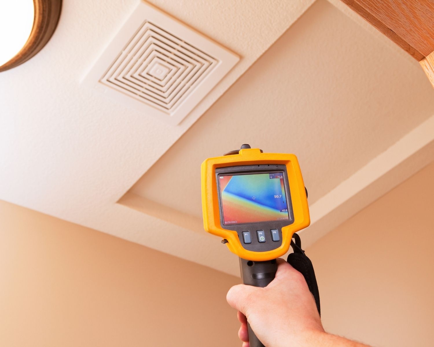 Thermal imaging camera revealing a cool moisture pattern on an interior wall after a leak