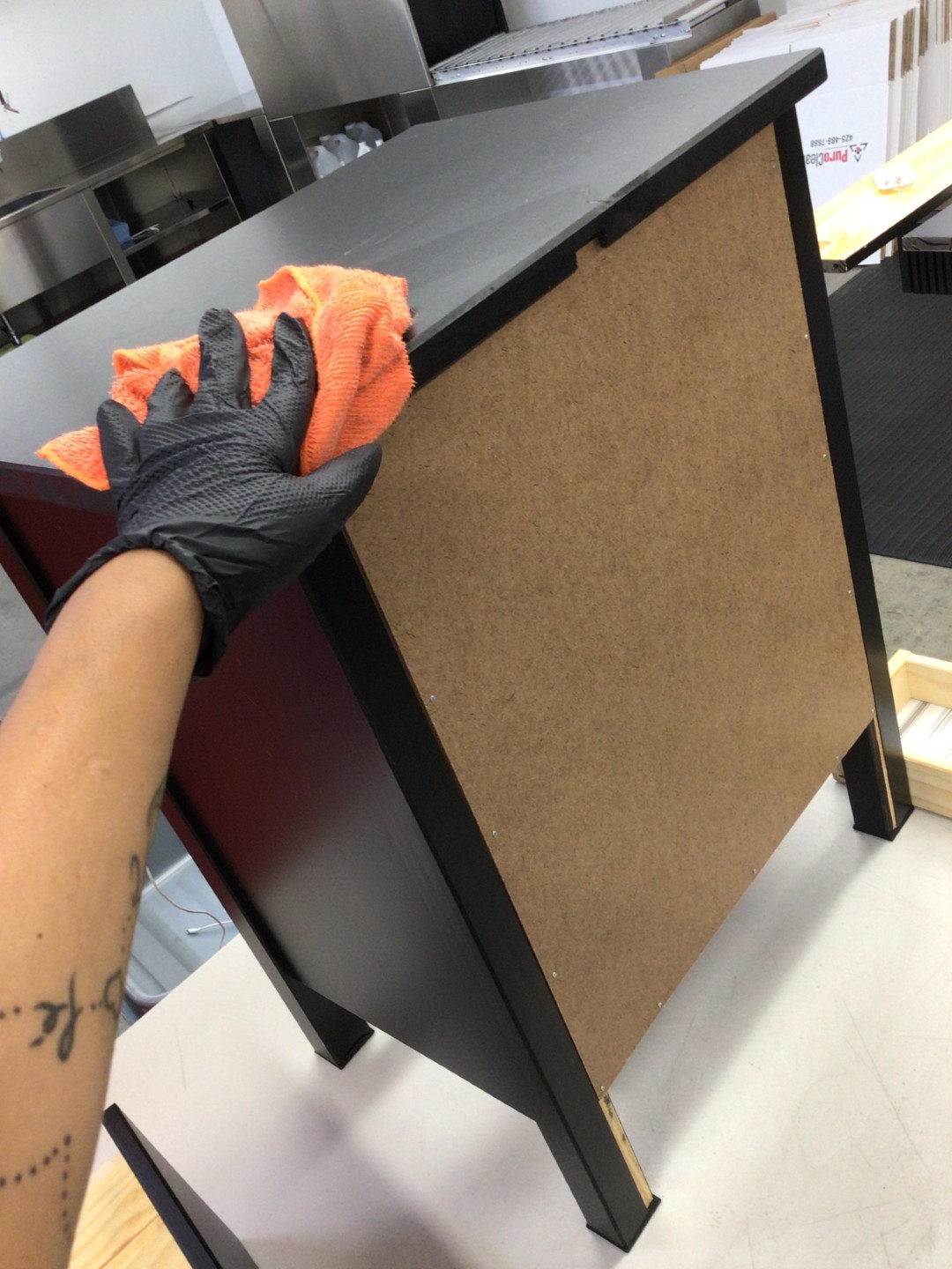 Hand-wiping soot from fire damaged furniture during contents cleaning