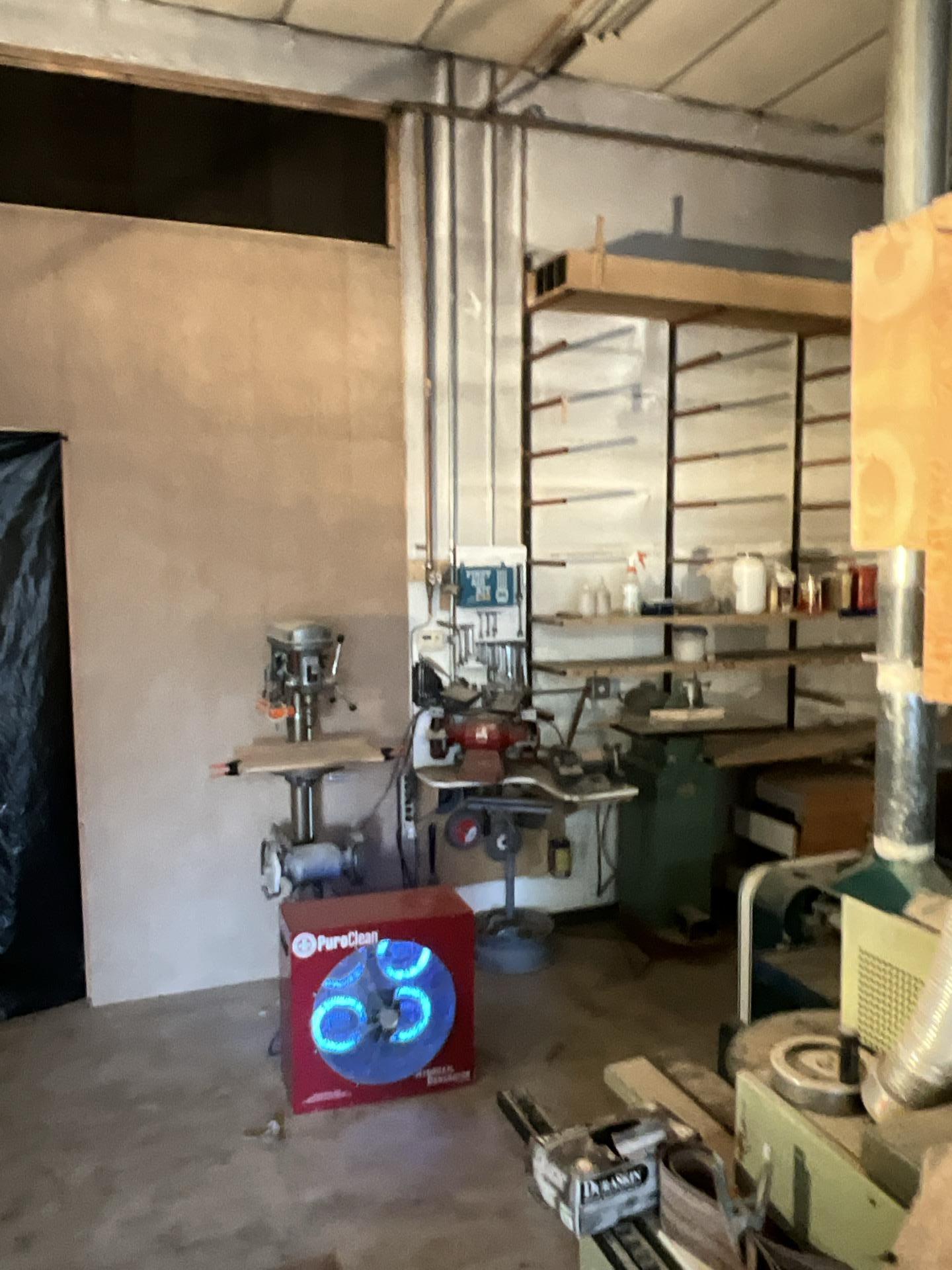 Air scrubber running among production machinery during smoke damage cleanup at a Seattle WA woodworking shop