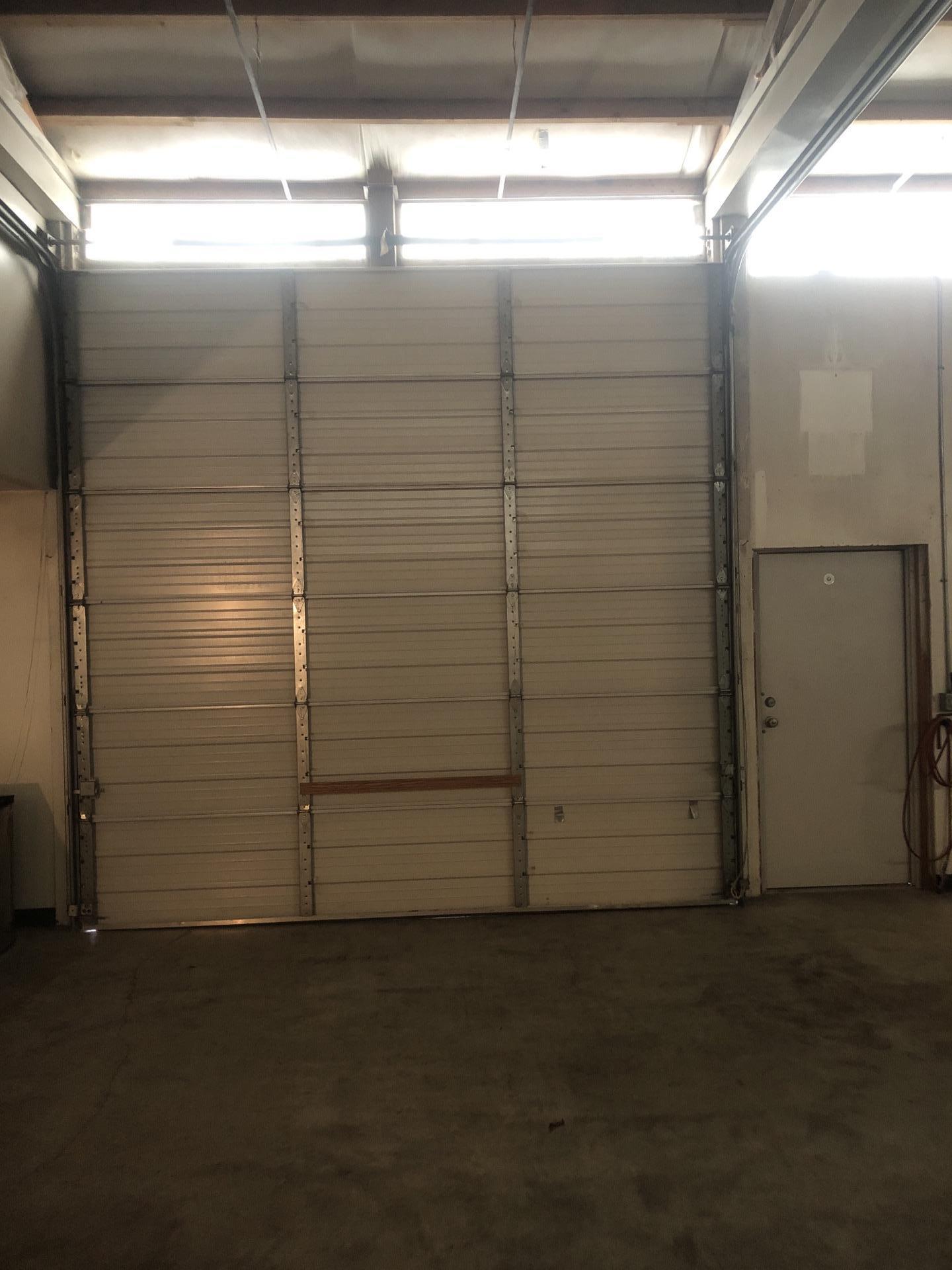 Restored shop bay and overhead door after commercial fire damage restoration in Seattle WA