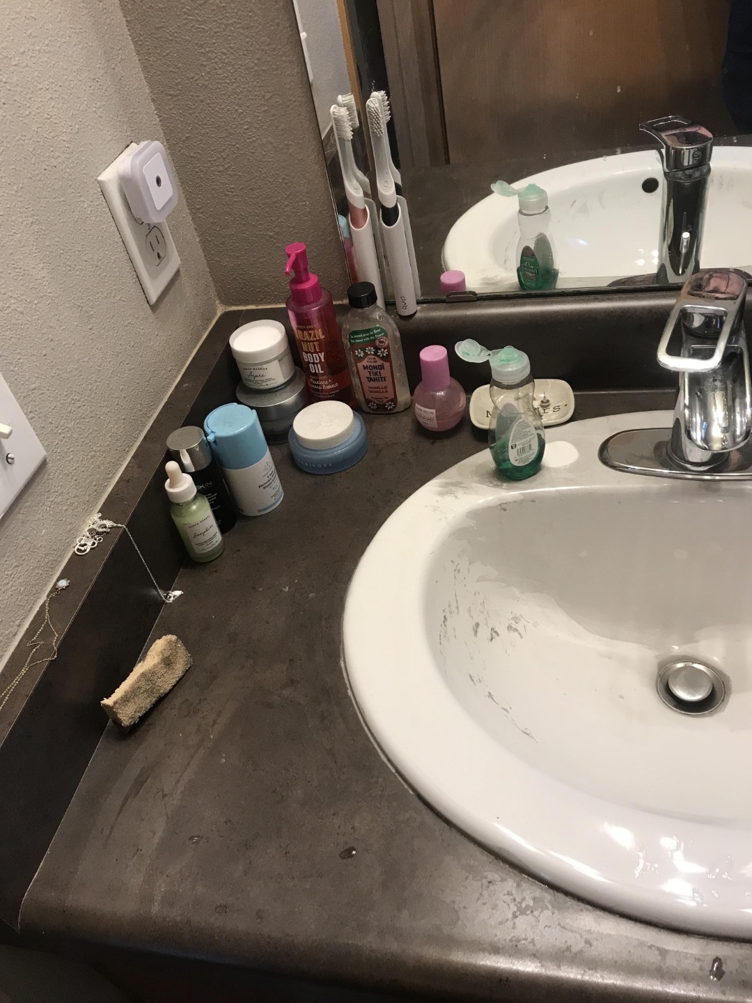 Soot film covering a bathroom vanity and fixtures on the second floor of a fire damaged Lake Stevens WA residence