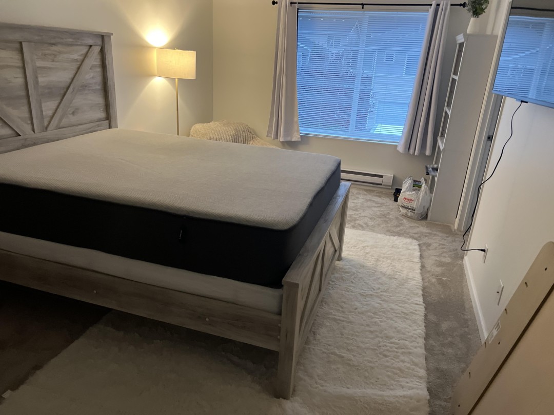 Restored master bedroom reset with the family's own cleaned furniture and bedding after a Lake Stevens WA house fire
