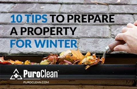 10 Tips to Prepare a property for winter with a hand cleaning leaves out of a gutter