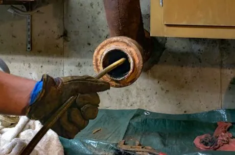 A drain being pulled out of the sewer.