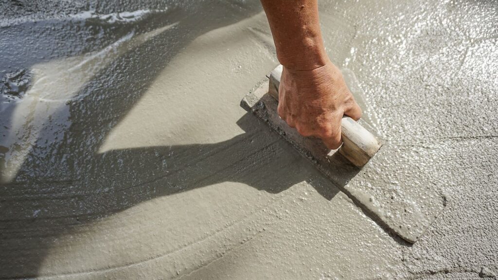 person smoothing concrete