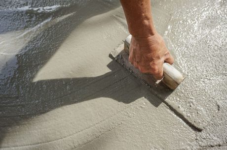 person smoothing concrete