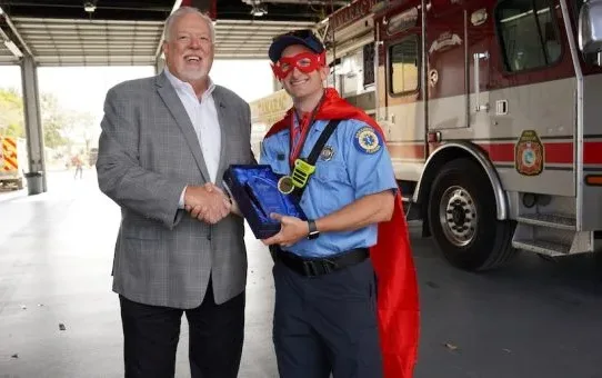 Steve White, COO of PuroClean, with the 2024 Superhero of the Year Award from the Superhero Campaign