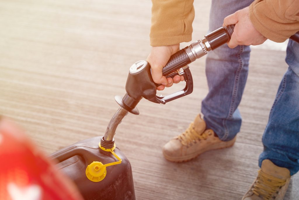 A man fills a gasoline can