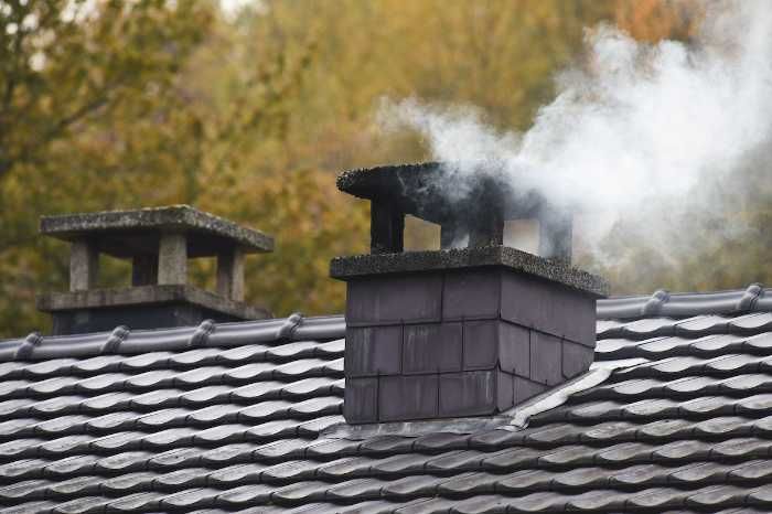 Smoke coming out of the house chimney