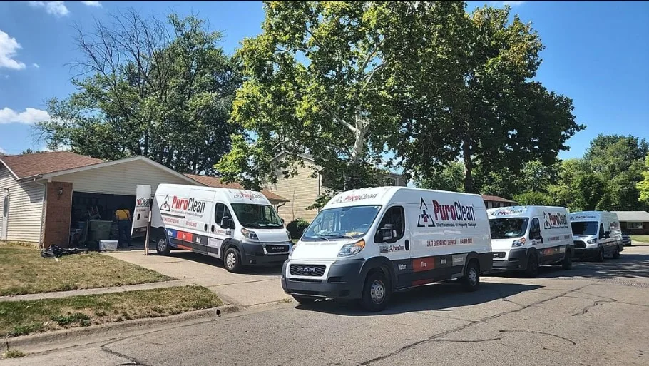 PuroClean technicians and vans at a home after a local disaster