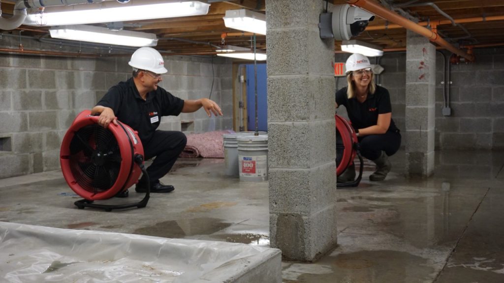 PuroClean technicians being trained in the crawlspace of PuroClean's state-of-the-art training 'Flood House.'