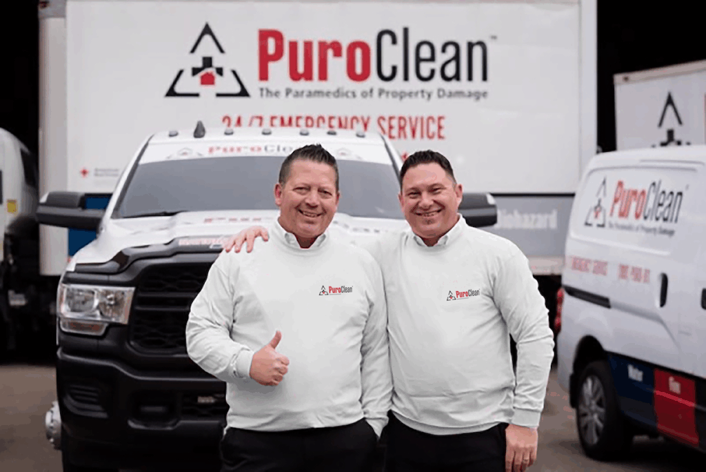 Keegan Trudgen and Tim Lohse in front of PuroClean trucks and vans
