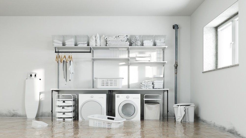 Flooded basement laundry room needing emergency water extraction and dehumidification services