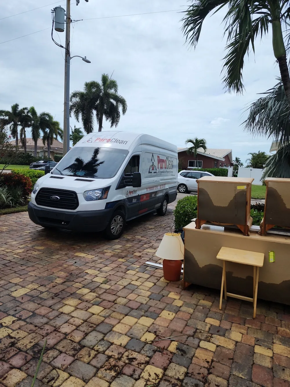 PuroClean van in a driveway performing water damage and mold remediation services after a weather related event