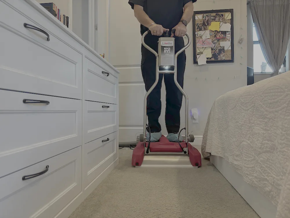 PuroClean technician using high powered carpet cleaner to perform carpet and upholstery cleaning services
