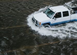 emergency preparation - truck driving through flood waters