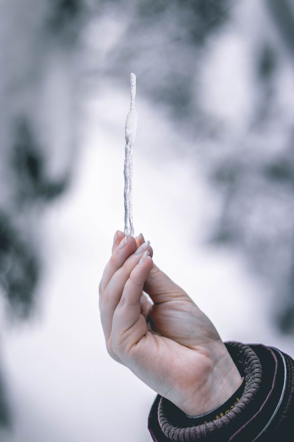 Frozen Pipes - woman holding icicle