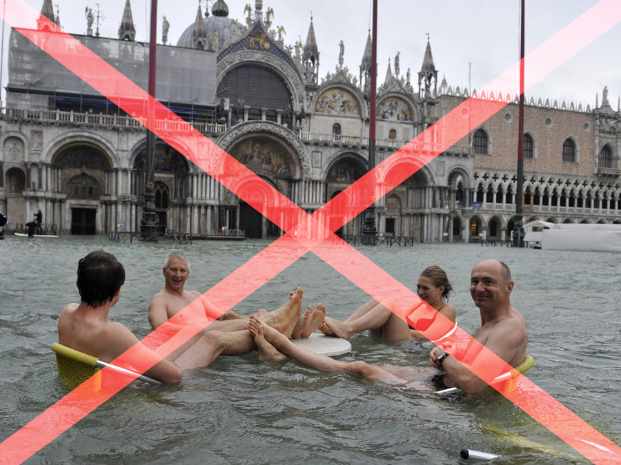 people playing in flooded street, having fun not following hurricane safety