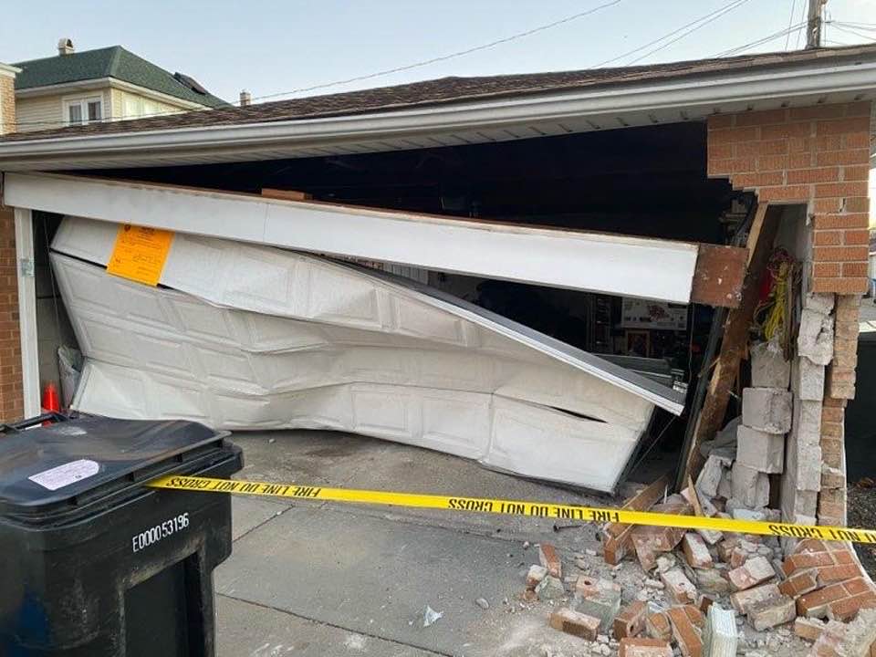 Damage to garage after car smashed into it.