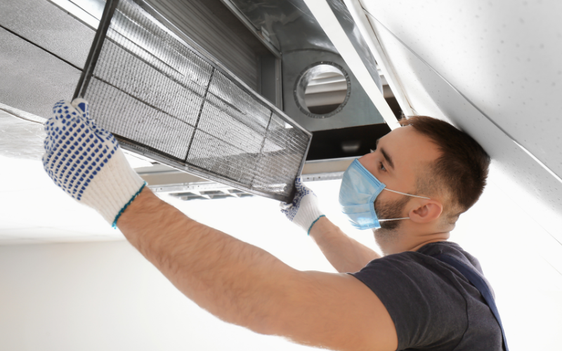 man cleaning mold in ac ducts